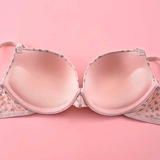 Woman wearing a light pink printed bra and thong-style panty set with glittery straps and soft finish.