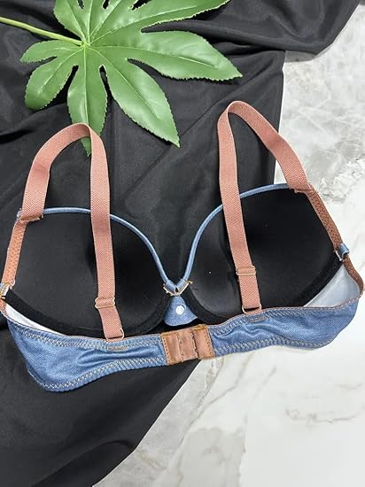 Woman wearing a dark blue-grey push-up bra with subtle sheen and structured cups.